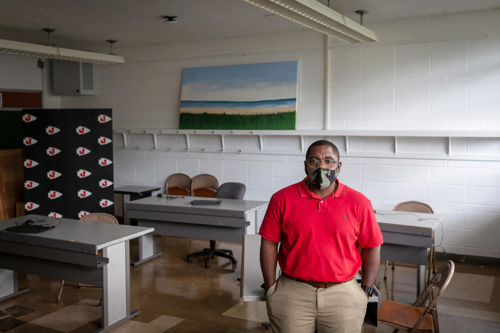 Business teacher Marc Reid spaced out tables in the classroom he's teaching in this summer. He said it can be hard to hear his students when they're spread out and talking through masks.