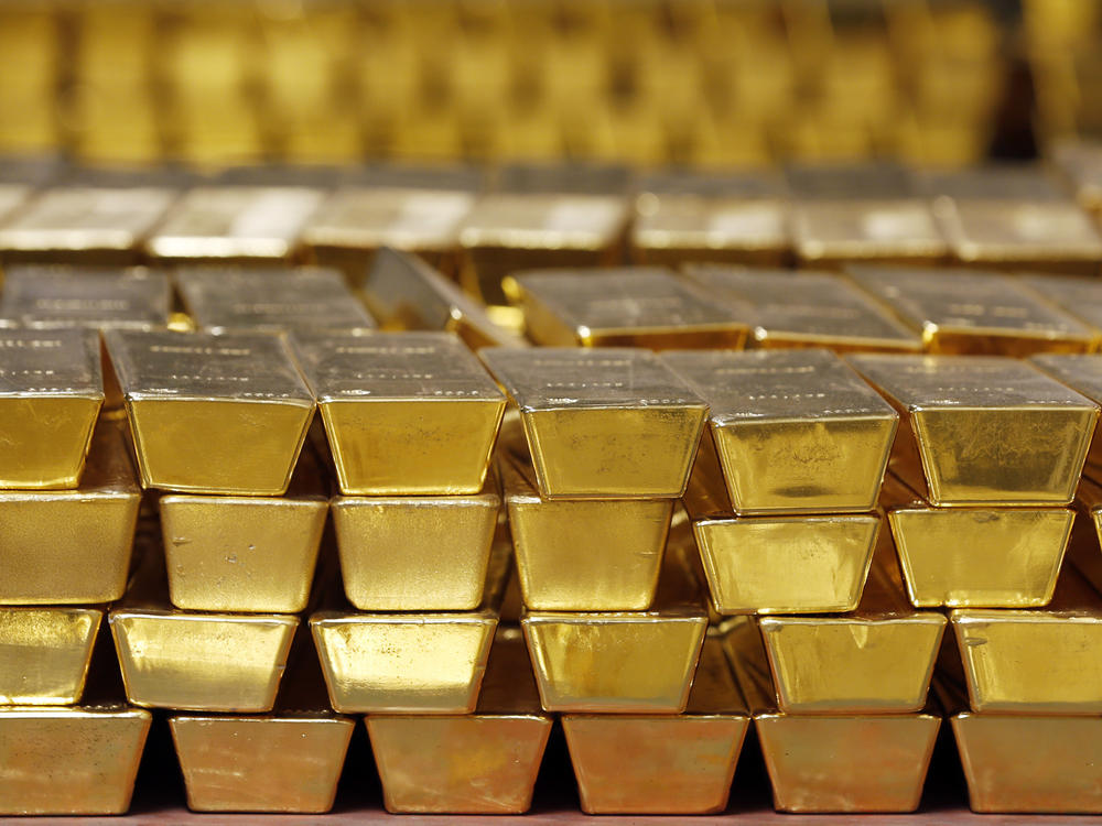 Gold bars are stacked in a vault at the United States Mint, in West Point, N.Y., in 2014. The settlement price for gold futures reached a record high of $1,931 per ounce Monday — and many analysts predict the price will head even higher.