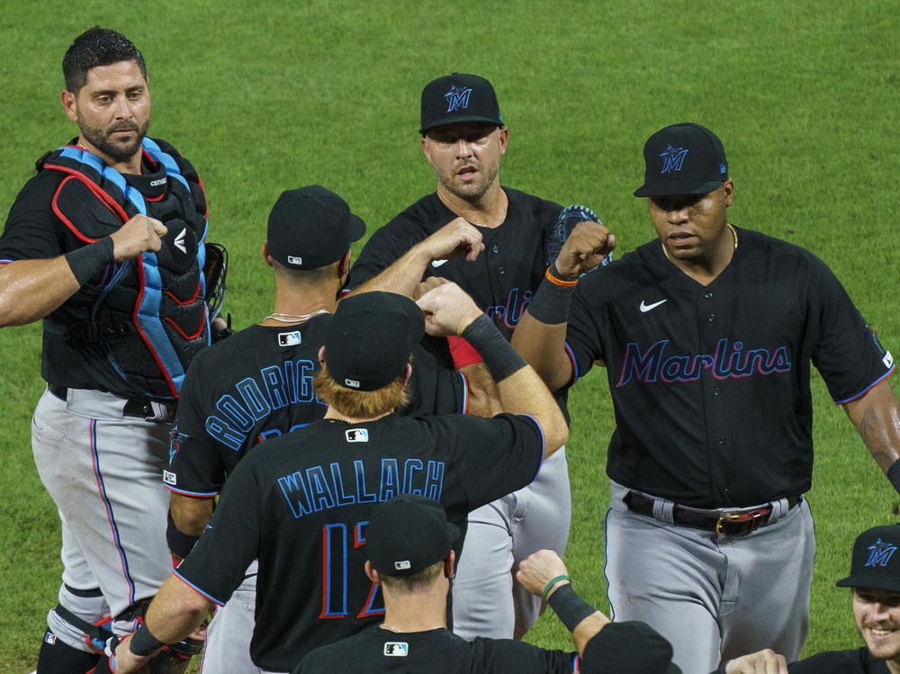 Members of the Miami Marlins celebrate a 5-2 win Friday against the Philadelphia Phillies. The Marlins' home opener Monday against the Baltimore Orioles has been postponed.