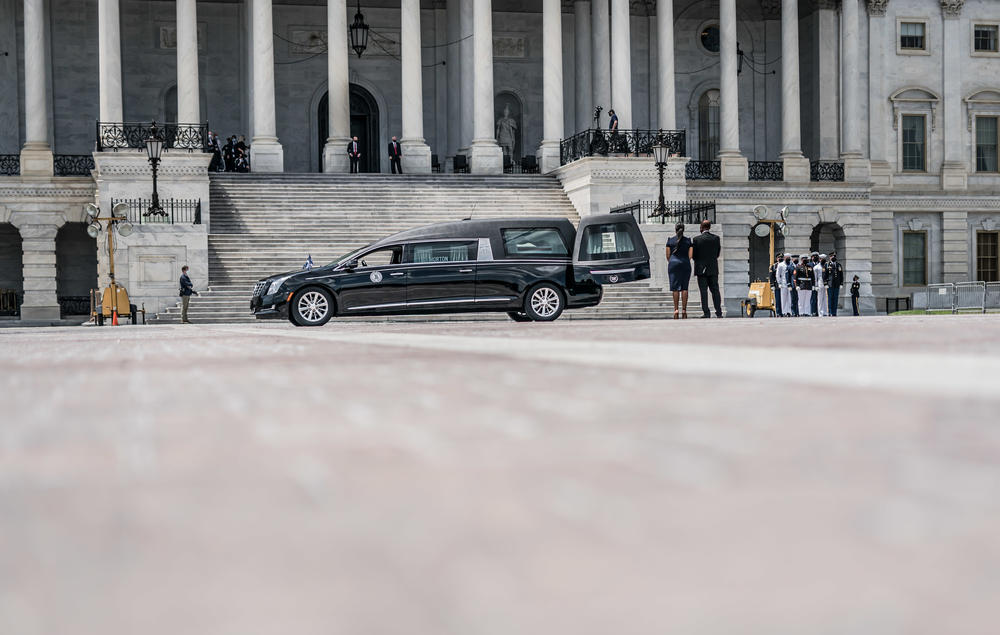 The remains of Lewis arrive at the Capitol as everyone stands for a moment of silence.