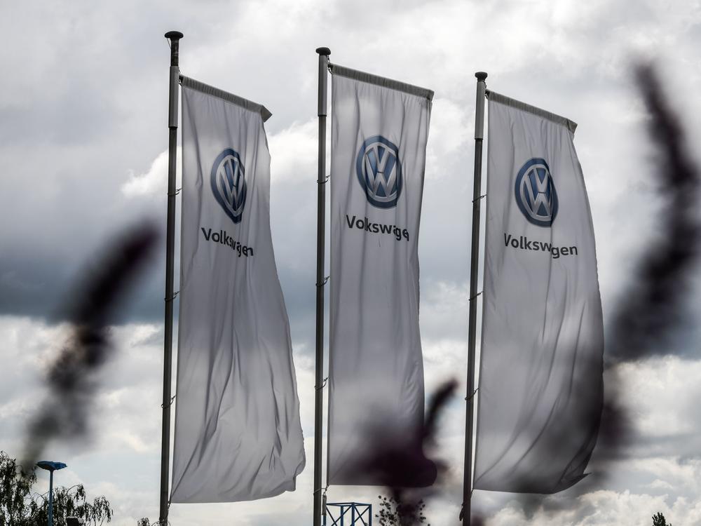 The logo of German automaker Volkswagen appears on flags fluttering in front of a car dealer in Hamm, Germany, in May. One of VW's many legal settlements over the Dieselgate scandal has finally reached its conclusion, the FTC says.