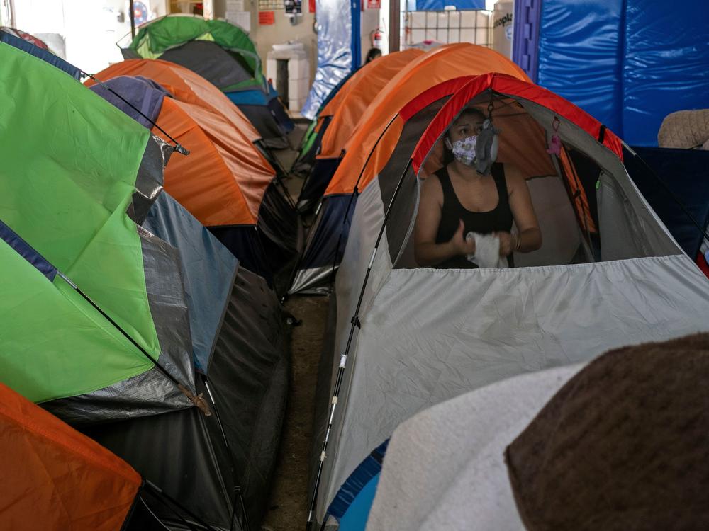 Mexican asylum seeker Eily Sanchez cleans her tent at a migrant shelter in Tijuana, Mexico, last month.