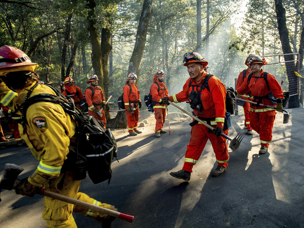 Inmate firefighters battle California's Kincade Fire on Oct. 29, 2019. In late June, officials locked down 12 inmate fire camps after outbreaks of the coronavirus within the state's prison system.