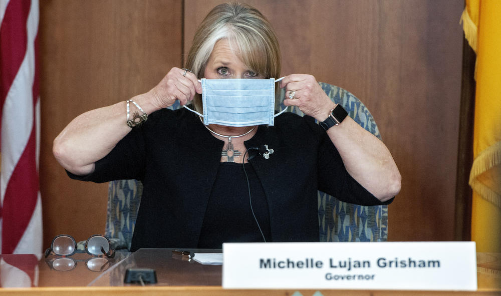 Lujan Grisham puts on her face mask when not speaking during an April 15 update on the COVID-19 outbreak in the state.