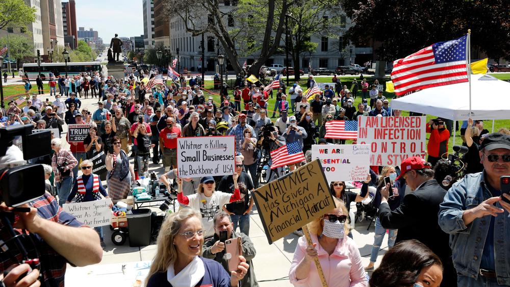 Protesters march outside the Michigan state Capitol in Lansing on May 20, denouncing Whitmer's coronavirus closures.