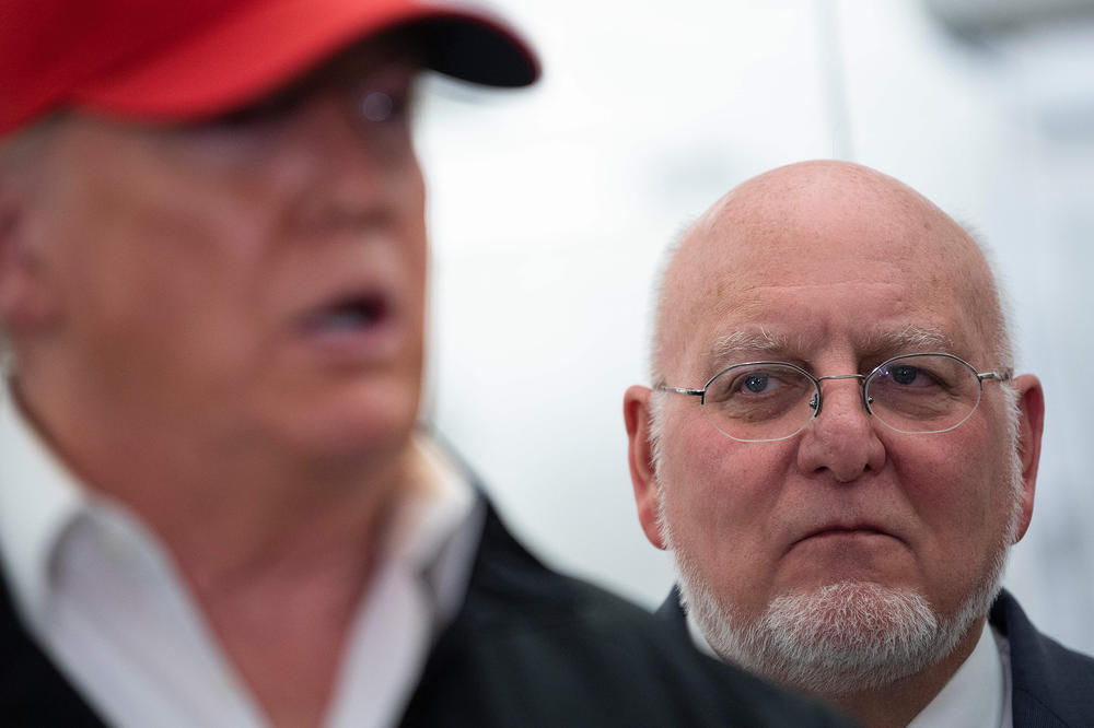 CDC Director Dr. Robert Redfield, right, listens as President Trump speaks during a tour of the CDC in Atlanta on March 6, 2020.