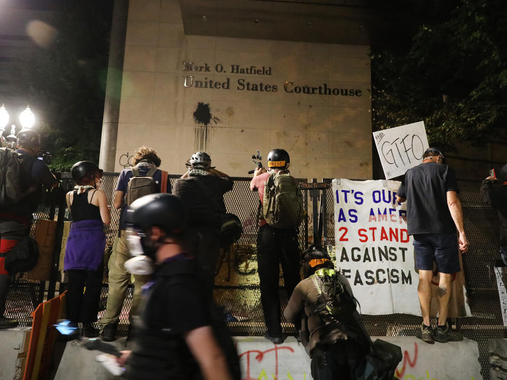 Protesters gather in front of the Mark O. Hatfield federal courthouse in downtown Portland, where some demonstrators have been arrested and others released from jail on the condition that they not attend any more protests.