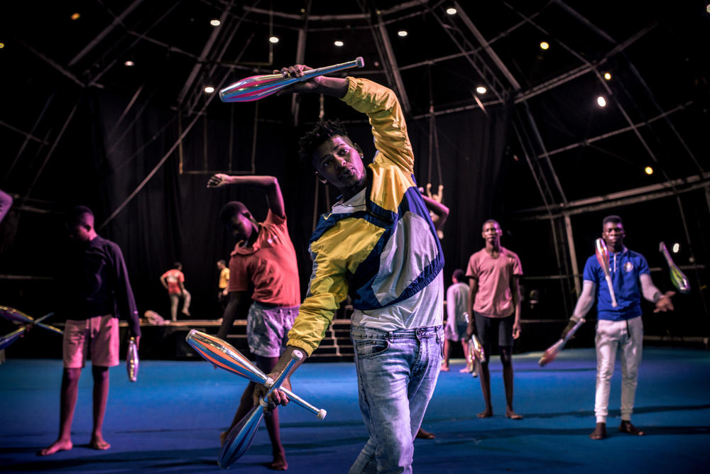 Thabo Gxoyiyana and fellow performers rehearse their juggling act at the Zip Zap dome in Cape Town's city center.