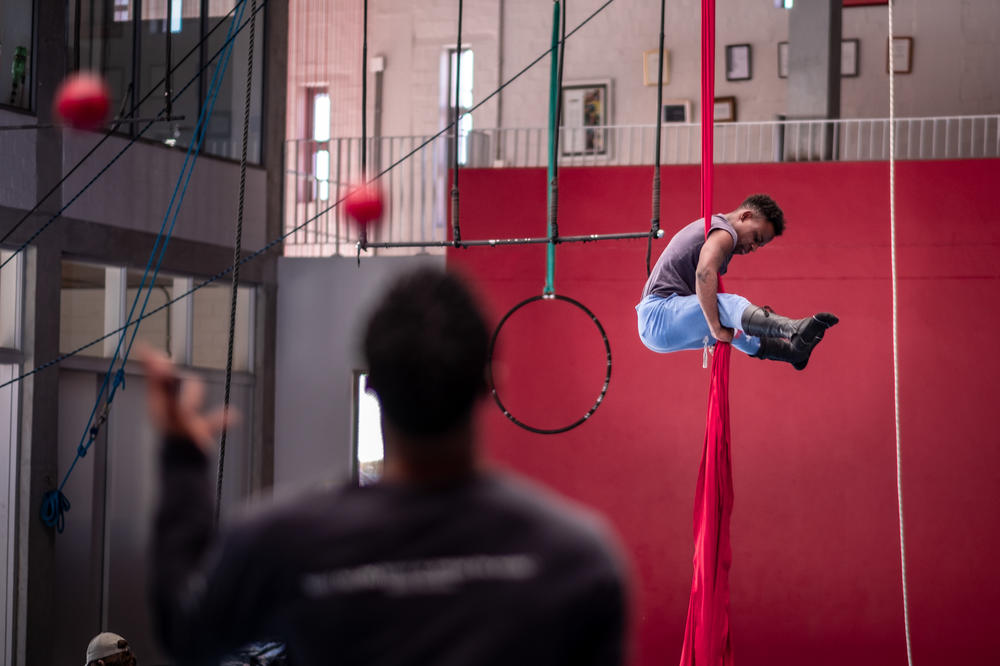 Xolani Sikunana rehearses his act — acrobatics while hanging from long strips of silk — at the Zip Zap circus school in Cape Town, South Africa.