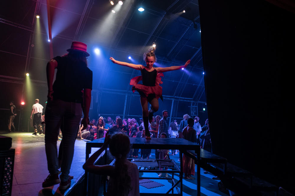 Leah Philander jumps off the stage after a performance.