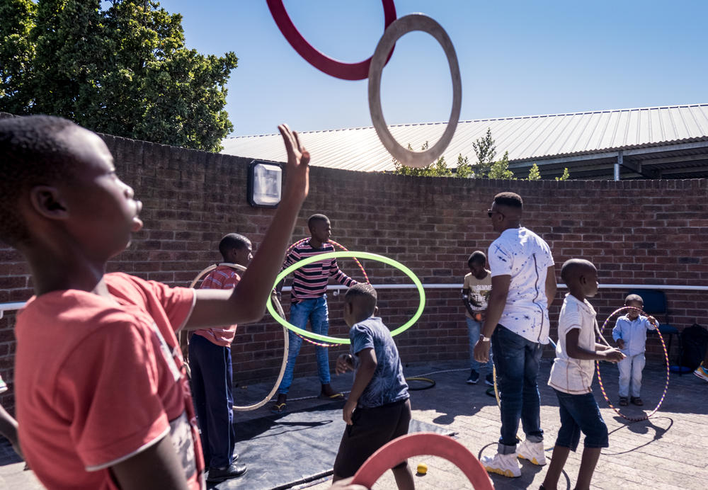 Children who are hospital patients practice circus tricks outside a hospital in the township of Khayelitsha, Cape Town. Zip Zap's Ubuntu program aims to introduce children with medical conditions to the world of circus.