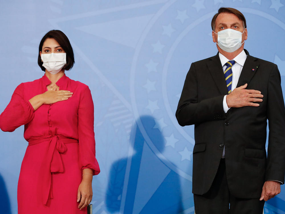 Michelle Bolsonaro tested positive on Thursday — days after her husband, Brazilian President Jair Bolsonaro, said he had recovered from the disease. The pair are seen here at an event on Wednesday.