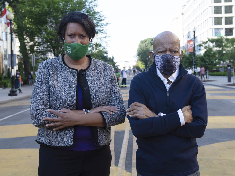 Washington, D.C., Mayor Muriel Bowser and Lewis look over a section of 16th Street renamed Black Lives Matter Plaza on June 7 in the nation's capital. It was the congressman's last public appearance.