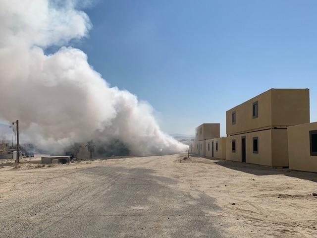 Smoke billows up at the mock village of Seize Razish.