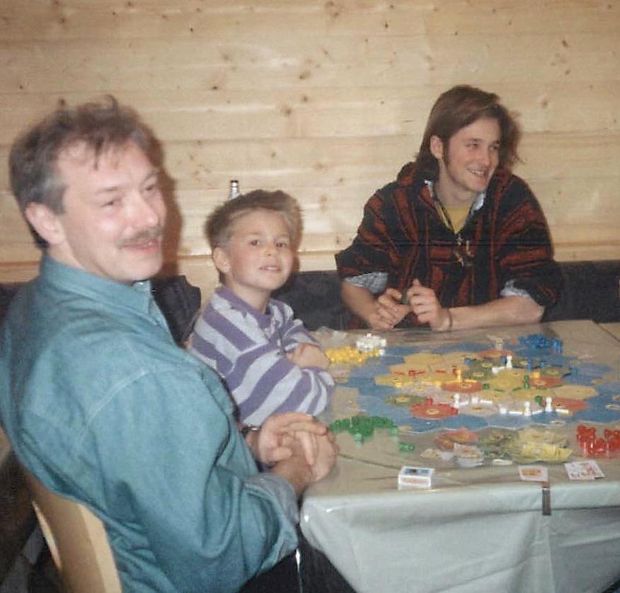 A Teuber family photo from 1994 shows Klaus (left), Benjamin and Guido Teuber playing a test version of the Catan game. Catan creator Klaus Teuber says the family still plays together but admits he usually loses.