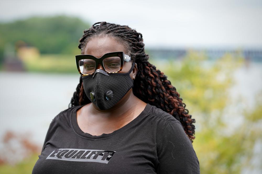 Poet and author Hannah Drake is working on a memorial dedicated to Black people whose names have been lost to history. She's shown above standing near the Ohio River in Louisville on July 23, 2020.