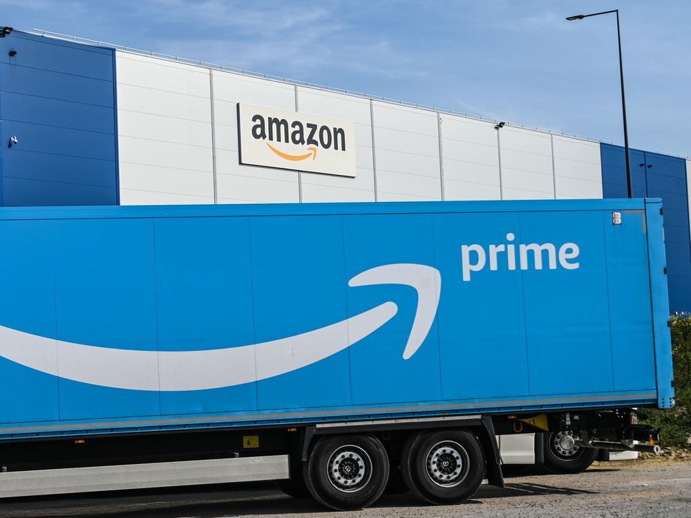 An Amazon delivery truck is parked outside a warehouse in France on April 16. The online retail giant's revenues and profits soared in the second quarter.