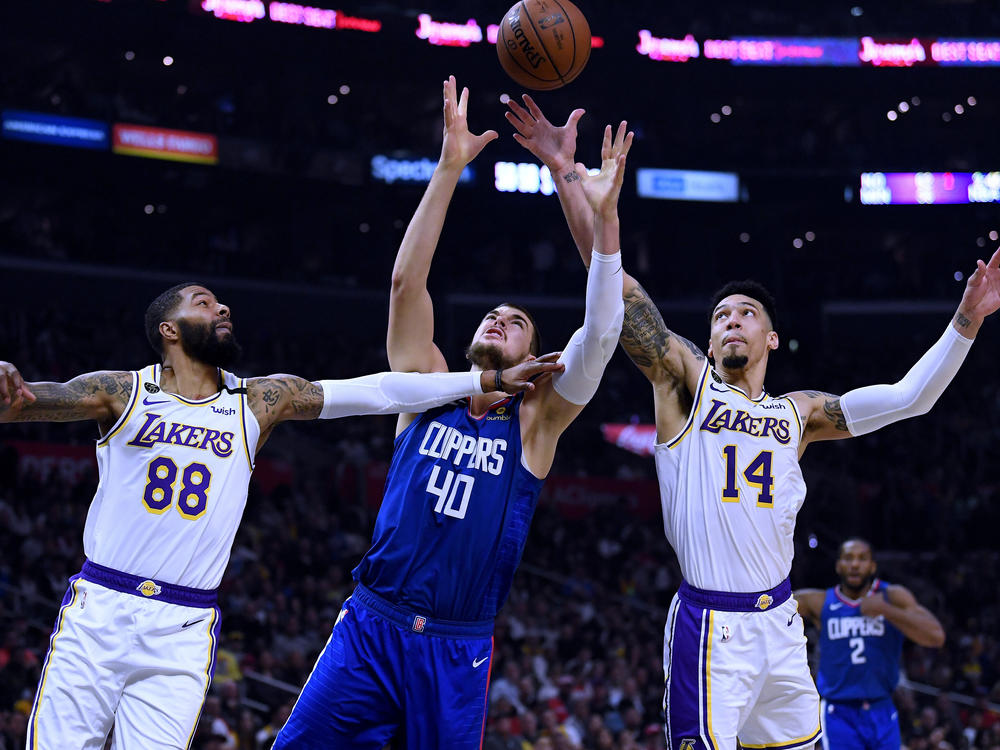 Players from the Los Angeles Clippers and Los Angeles Lakers, shown here during a game in March, will face each other on Thursday evening as the NBA season restarts.
