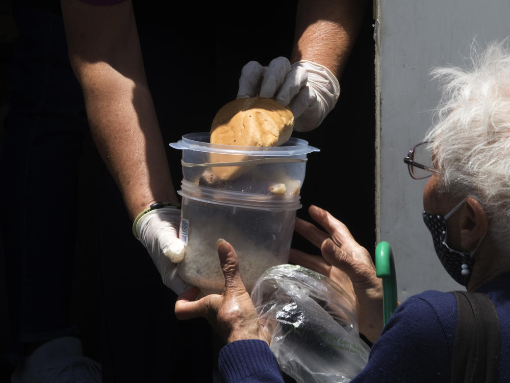 A woman receives a food ration last month at a food truck installed outside La Raza National Medical Center in Azcapotzalco in Mexico City.