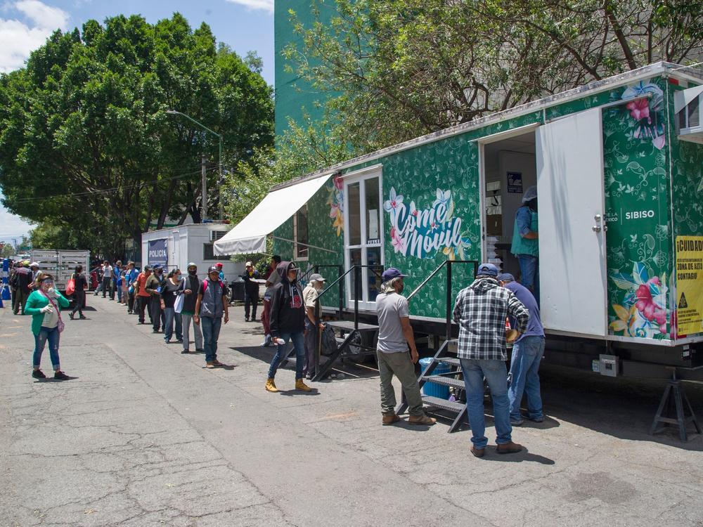 People line up to receive food last month at a food truck outside La Raza National Medical Center in Azcapotzalco in northern Mexico City.