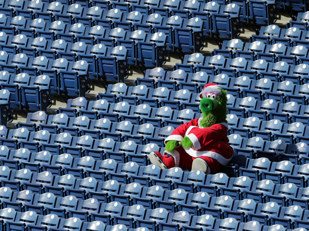 The Phillie Phanatic sits alone in the stands during a game between the Miami Marlins and the Philadelphia Phillies on Saturday. During this series, as many as 19 Marlins players and coaches had already been infected with the coronavirus.
