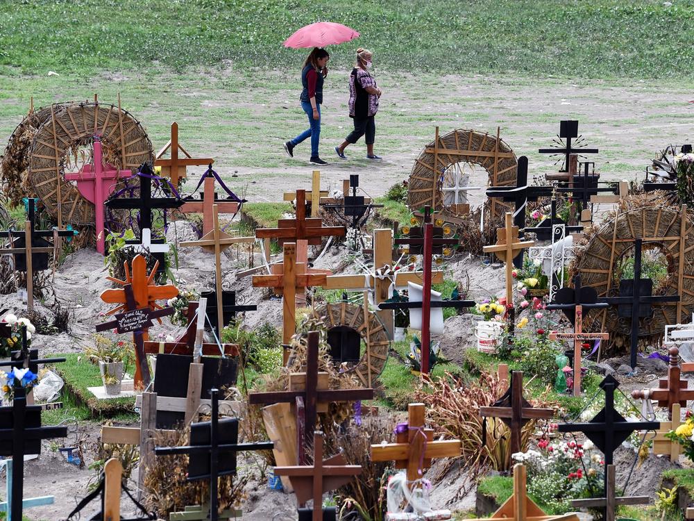 Relatives of those who have died from COVID-19 visit graves in the special area of the Municipal Pantheon of Valle de Chalco, Mexico. The coronavirus has taken a heavy toll on the country, especially its poorest citizens.