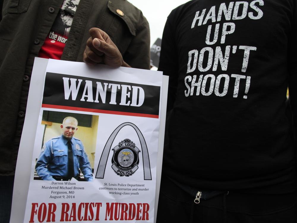 Demonstrators hold a sign in St. Louis, Mo., following the 2014 shooting death of 18-year-old Michael Brown.