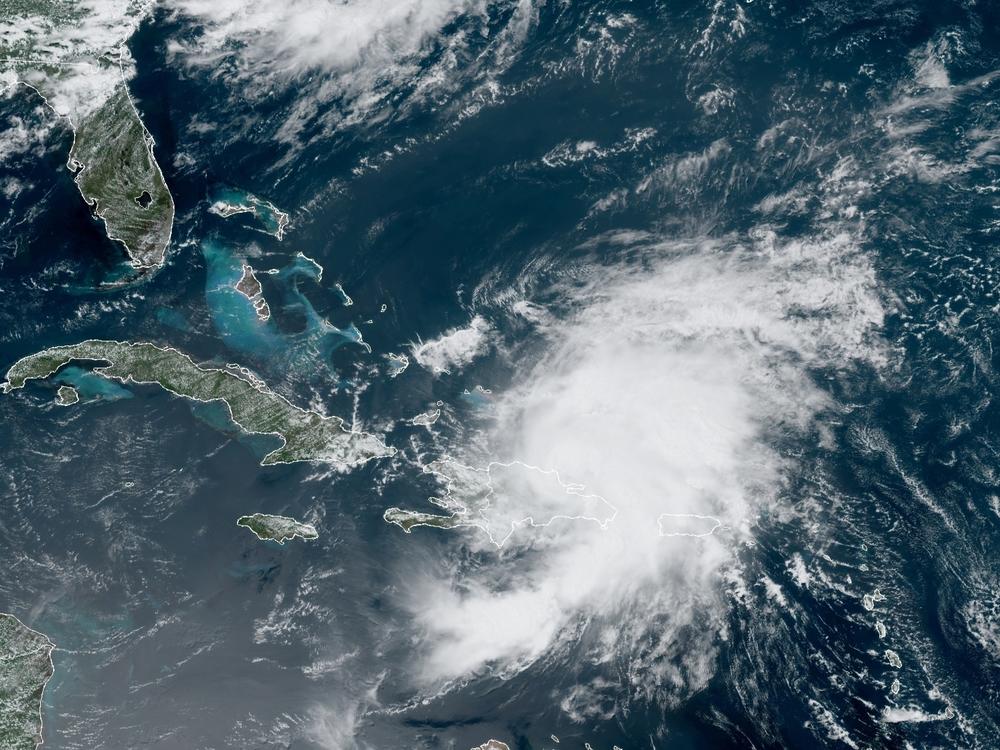 A satellite image from Thursday morning shows Tropical Storm Isaias looming over Puerto Rico and the Dominican Republic. The storm is predicted to drench Florida's east coast over the weekend.