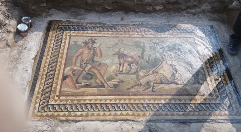 A screenshot from a video from a Facebook group devoted to looting and selling antiquities. A narrator speaking Syrian-accented Arabic describes an elaborate, Roman-era mosaic depicting mythological figures and animals believed to be in northwestern Syria – a conflict zone where there has been extensive looting of illegally excavated antiquities.