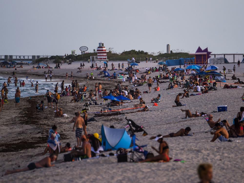 People relax on the beach in Miami Beach on Tuesday.