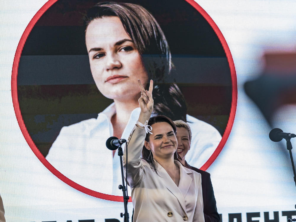 Svetlana Tikhanovskaya, presidential candidate in Belarus elections 2020, makes the symbol of victory in a rally in Minsk.