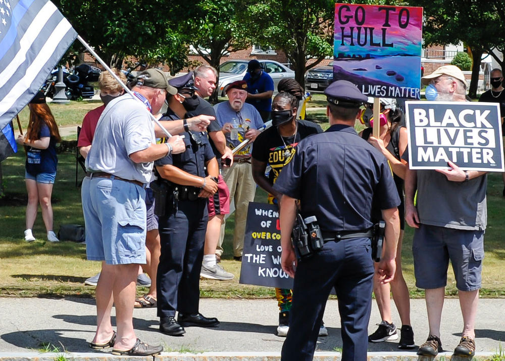 Demonstrators clash this week at a rally outside the Hingham Police Department in Hingham, Mass. A controversy has raged since firefighters hung 