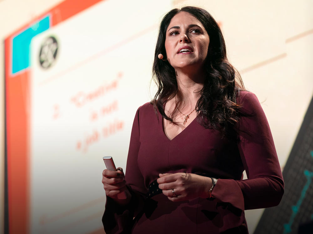 Dr. Laurel Braitman speaks from the TED stage.