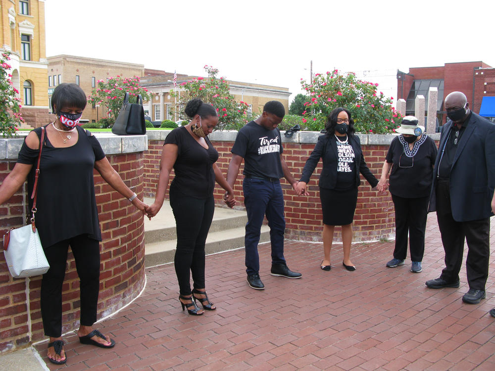Statue opponents gather for prayer at the courthouse before speaking at a recent meeting of the Harrison County Commissioner's Court.
