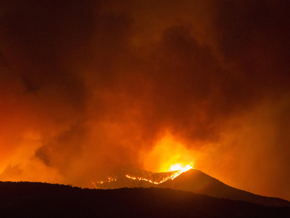 A brush fire burns amid the Apple Fire in Banning, Calif. on Saturday.