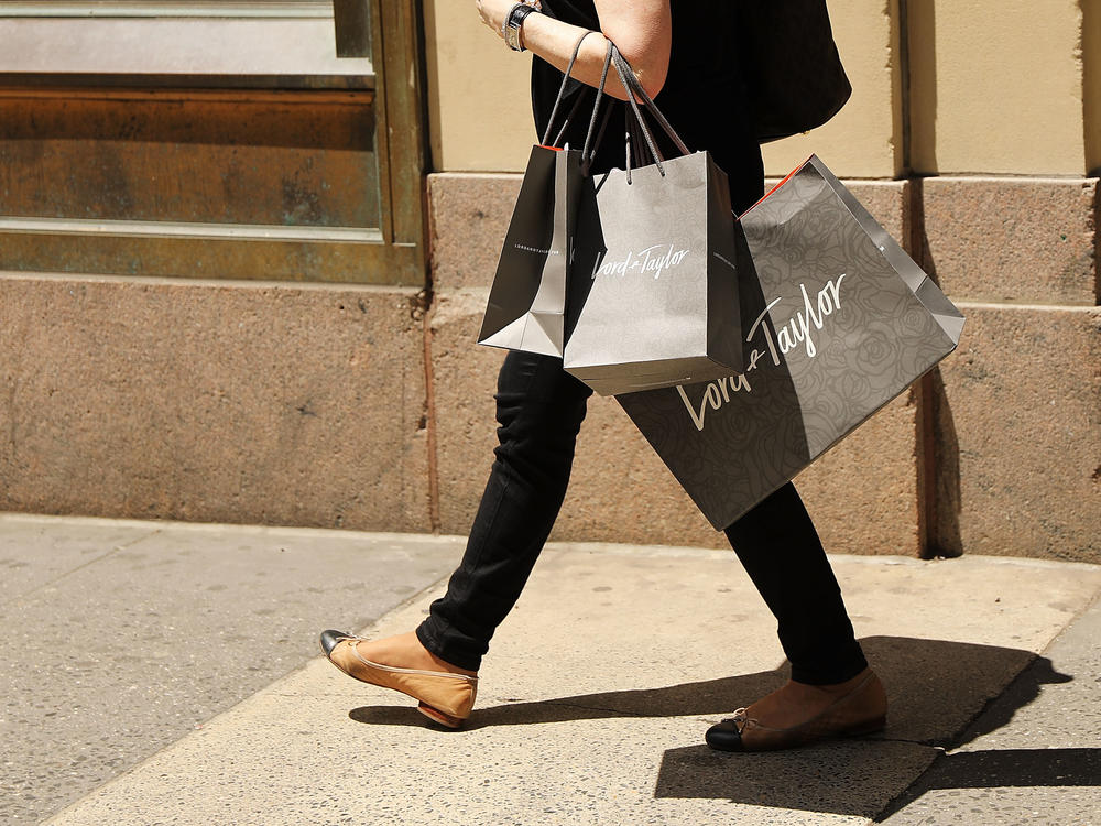 A woman walks out of Lord & Taylor's flagship store in Manhattan in June 2018, before the location was closed and the building was sold in 2019.
