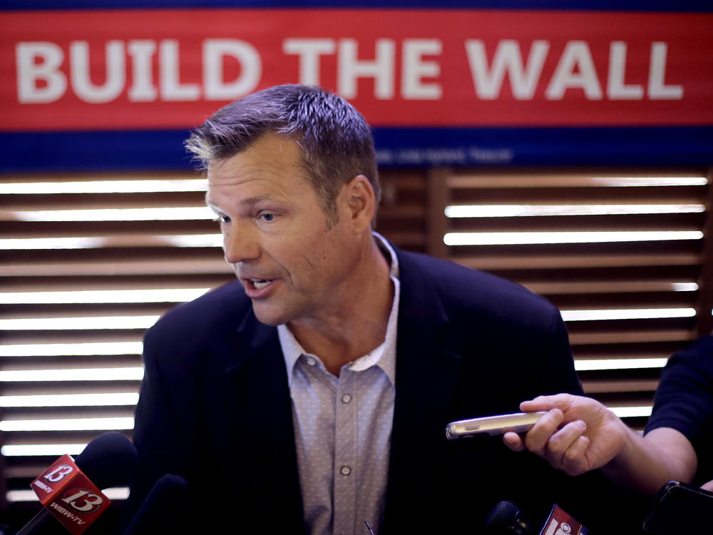 Former Kansas Secretary of State Kris Kobach talks to the media after announcing his Senate candidacy on July 8, 2019.