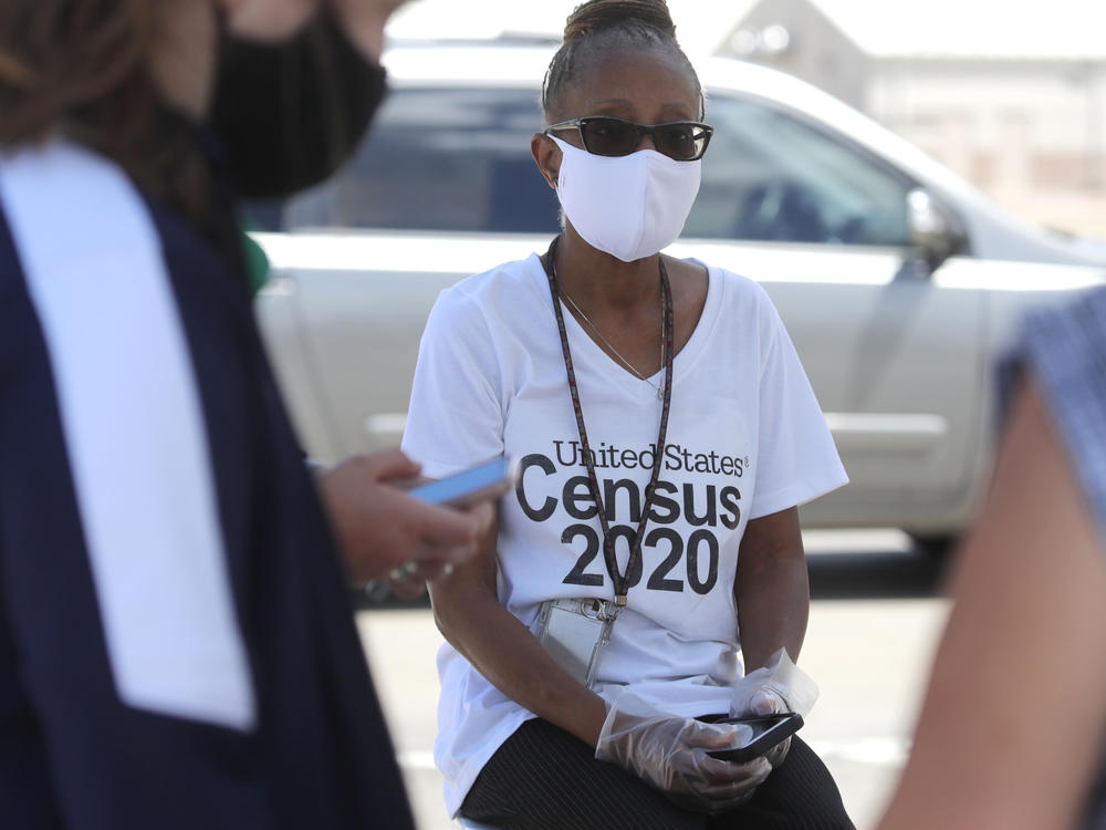 U.S. Census Bureau worker Jennifer Pope wears a face covering at a walk-up counting site in Greenville, Texas, on July 31. The bureau is ending all counting efforts for the 2020 census on Sept. 30, a month sooner than previously announced, the bureau's director confirmed Monday.