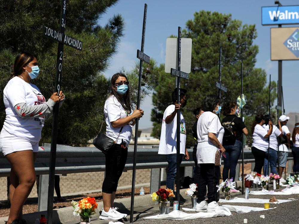 Mourners hold 23 crosses Monday in front of a Walmart honoring those killed in the 2019 attack in El Paso, Texas.