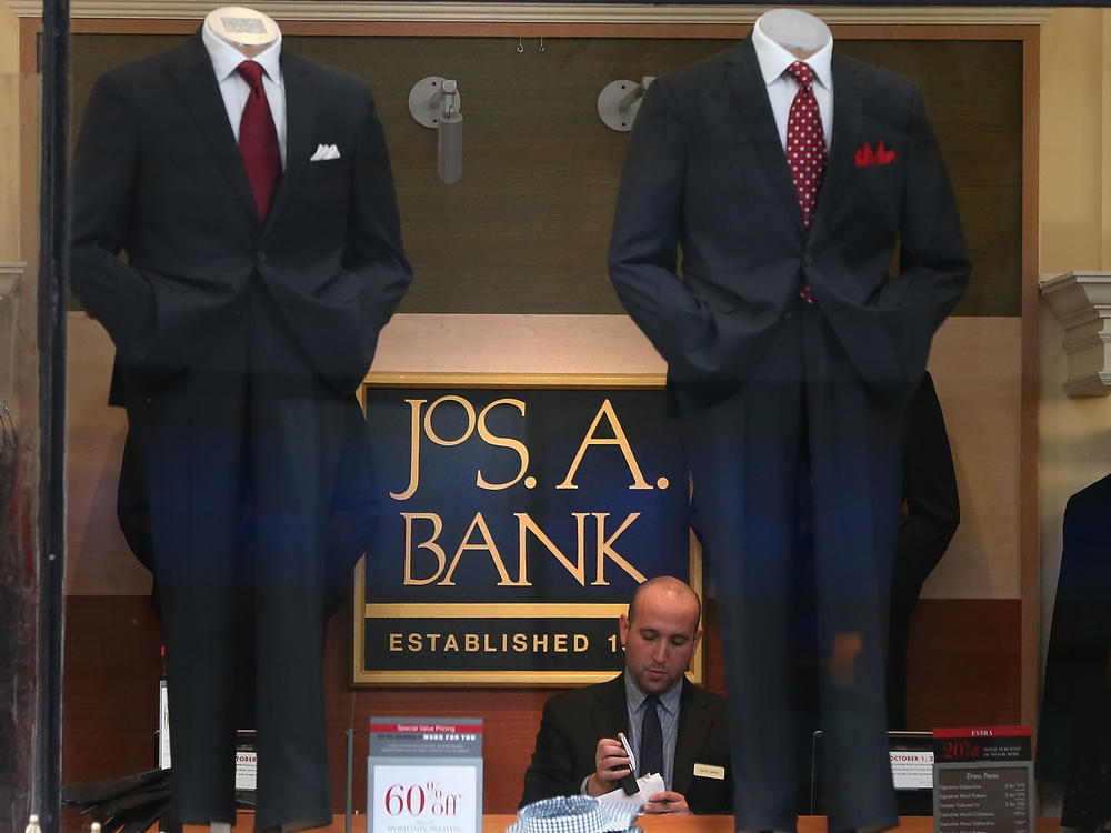 An employee works inside a Jos. A. Bank retail store in San Francisco. The parent company Tailored Brands earlier said it would close up to 500 stores and cut 20% of corporate jobs.
