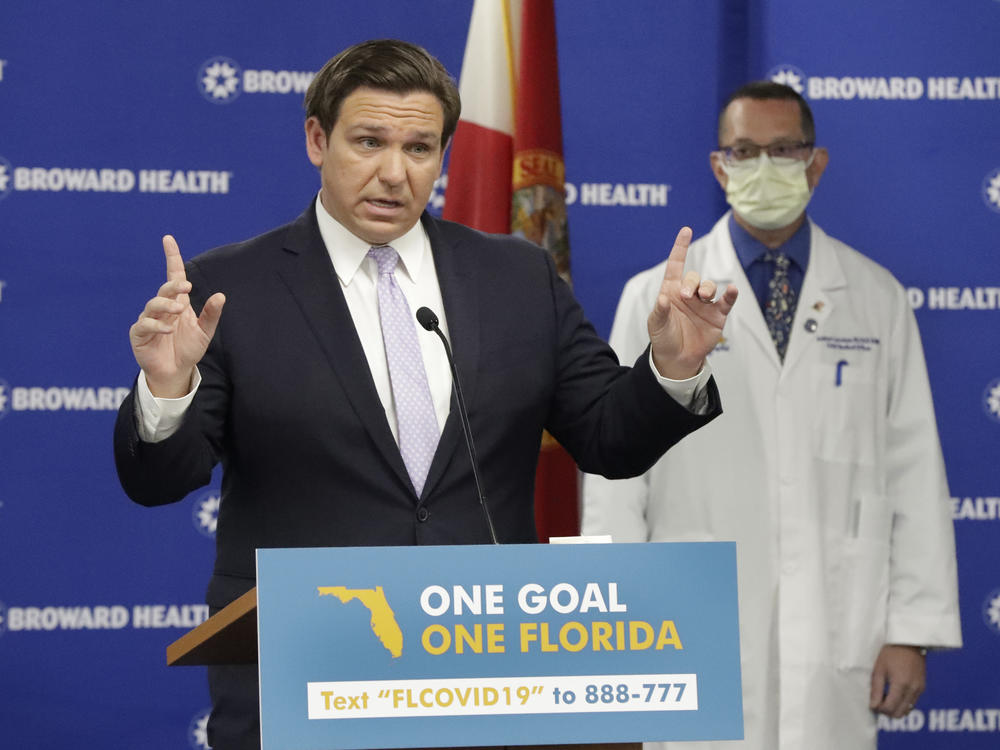 Florida Gov. Ron DeSantis speaks during a news conference Monday along with Dr. Joshua Lenchus, chief medical officer of Broward Health Medical Center. DeSantis says he's exploring ways to open nursing homes for family member visits.