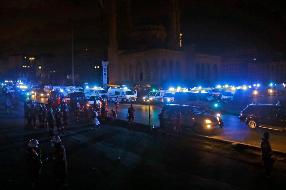Lebanese Red Cross ambulances gather outside the Mohammad al-Amin Mosque in Beirut on Tuesday as they set up search-and-rescue operations for victims following the massive explosion.