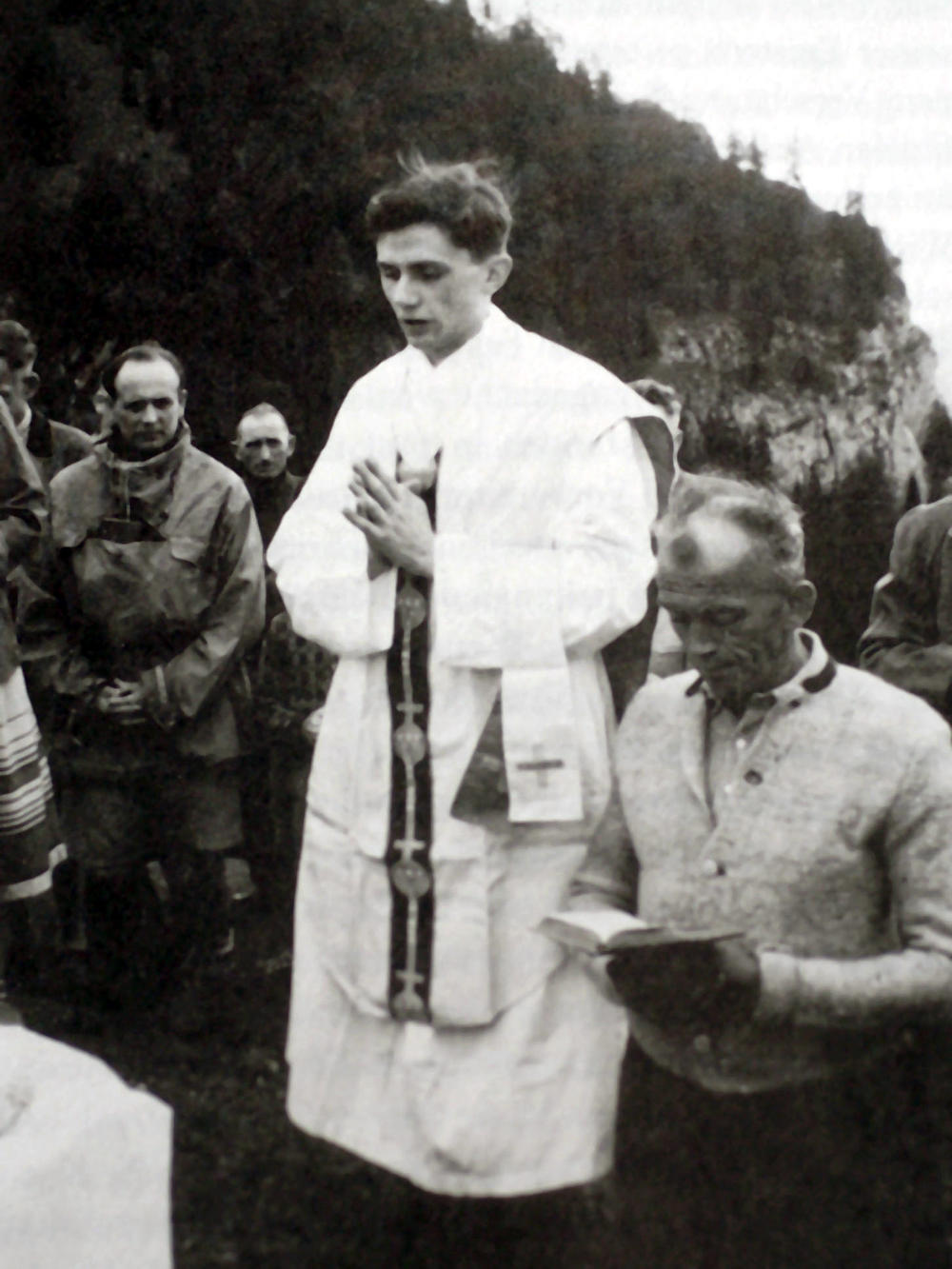 German priest Joseph Ratzinger (center) prays during an open-air Mass in the summer of 1952 near Ruhpolding in the German state of Bavaria.