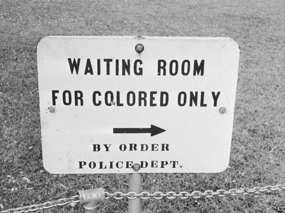 In her new book, <em>Caste, </em>Pulitzer Prize-winning journalist Isabel Wilkerson examines the laws and practices that created what she describes as a bipolar, Black and white caste system in the United States. Above, a sign in Jackson, Miss., in May 1961.