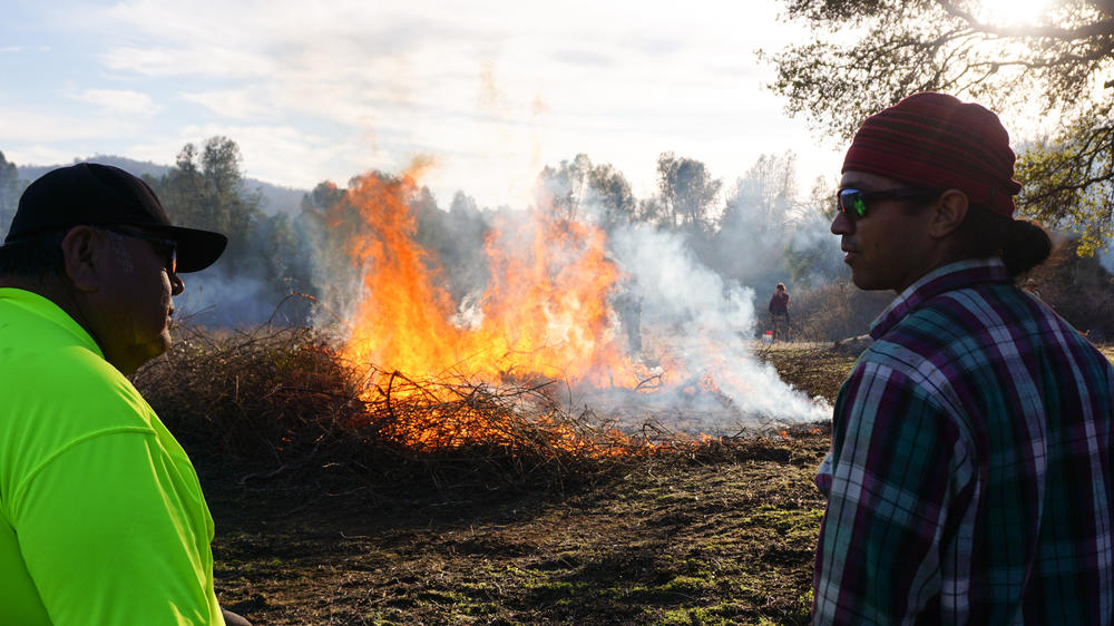 Ron Goode and Ray Gutteriez keep an eye on a burning sourberry bush.