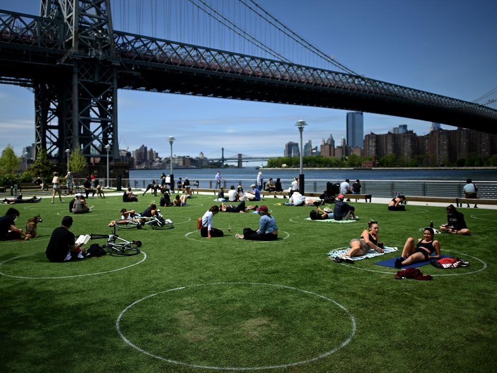 A new study has found that parks in low-income and majority-nonwhite communities are smaller and serve a larger number of people per park acre. People are seen here relaxing in May in Brooklyn's Domino Park.