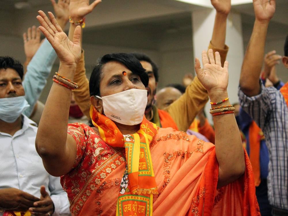 People attend a live telecast on a screen from Ayodhya of India's Prime Minister Narendra Modi participated in a ''Bhoomi Pujan'' or a groundbreaking ceremony to mark the building of a grand Ram temple, at Vivek Vihar, in New Delhi on Wednesday.