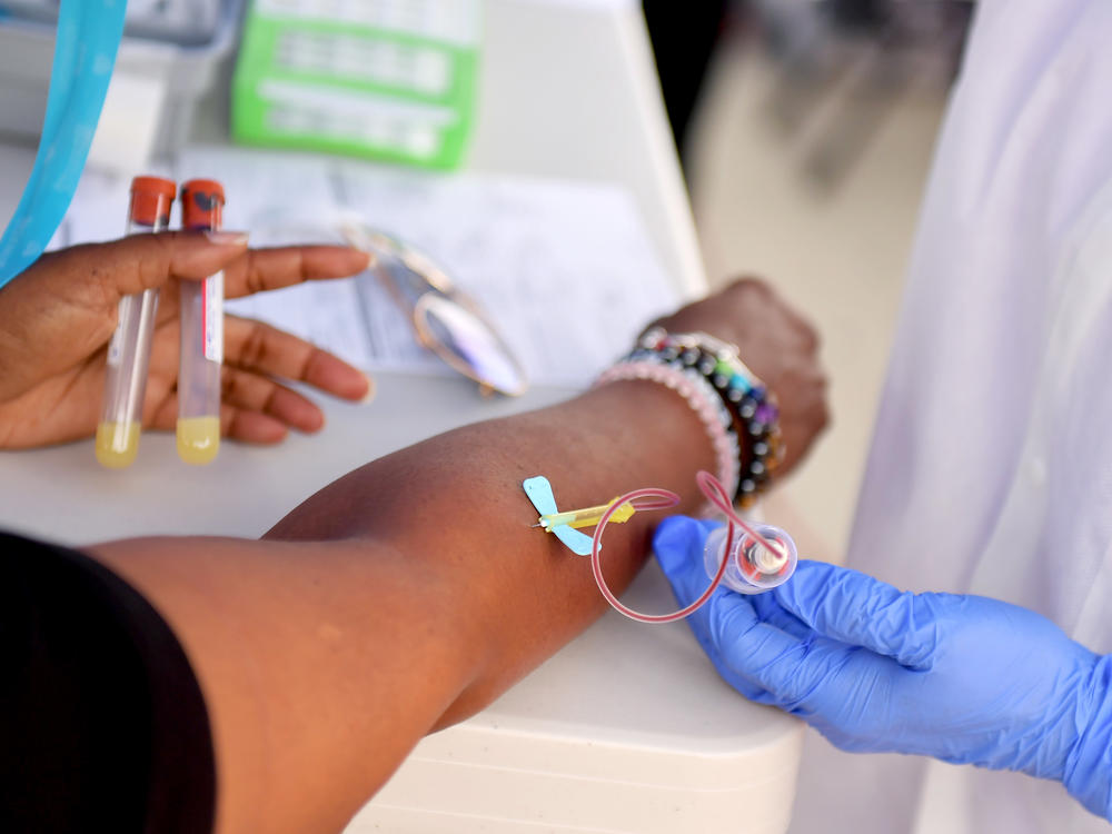 A medical worker draws blood at a free coronavirus antibody testing event in Los Angeles on Wednesday.