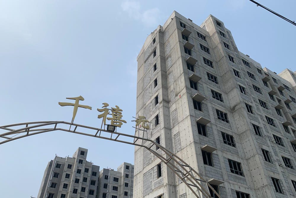 New high-rise apartments are under construction in villages around Heze, in eastern China's Shandong province. Rural residents say these complexes are too expensive, too far away from their fields and ill-suited for farmers.