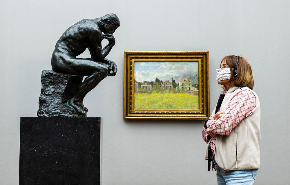A visitor looks at Rodin's <em>The Thinker</em> at Alte Nationalgalerie in Berlin in May 2020.